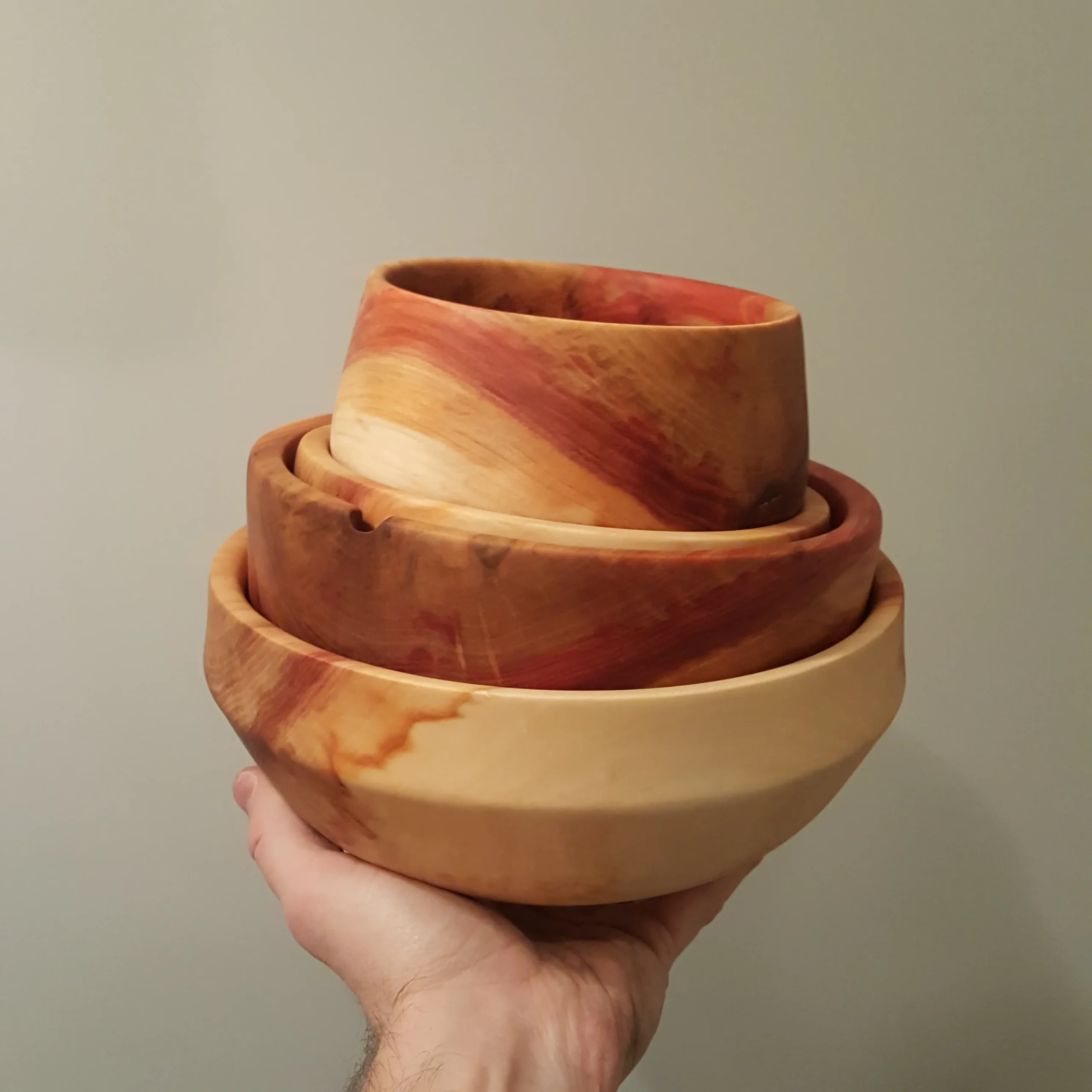 Hand holding four boxelder bowls